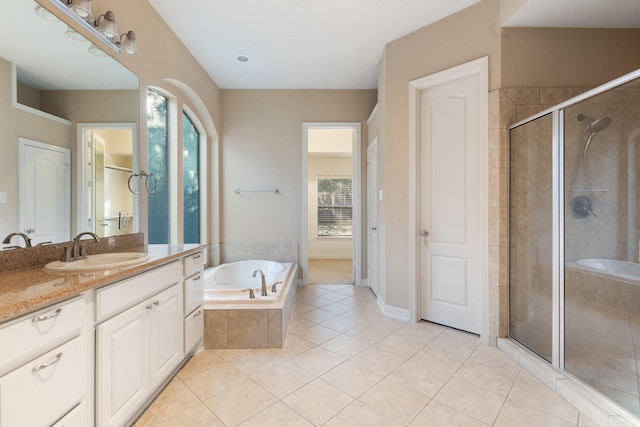 full bathroom featuring baseboards, tile patterned floors, a garden tub, vanity, and a shower stall