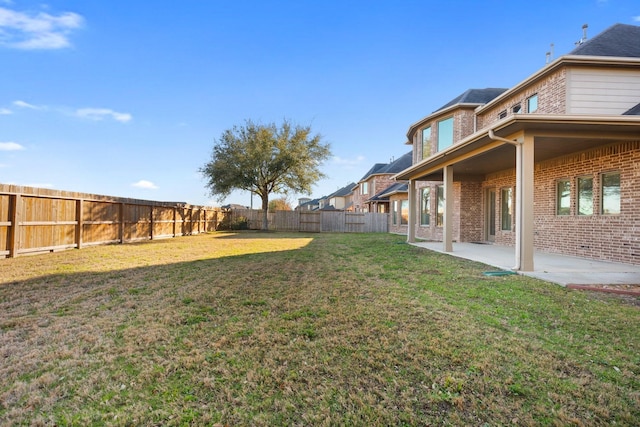 view of yard with a patio area and a fenced backyard