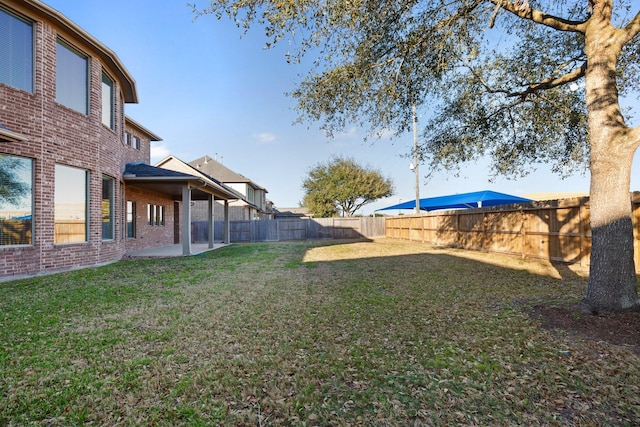 view of yard featuring a patio area and a fenced backyard