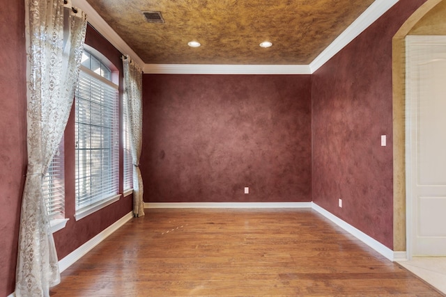 unfurnished room with plenty of natural light, baseboards, and wood finished floors