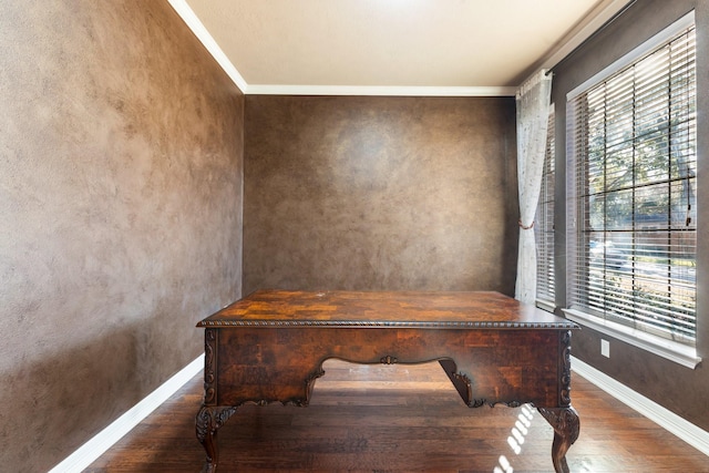 office space featuring ornamental molding, wood finished floors, and baseboards