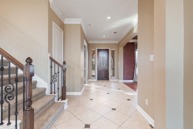 entrance foyer featuring arched walkways, crown molding, light tile patterned floors, visible vents, and baseboards