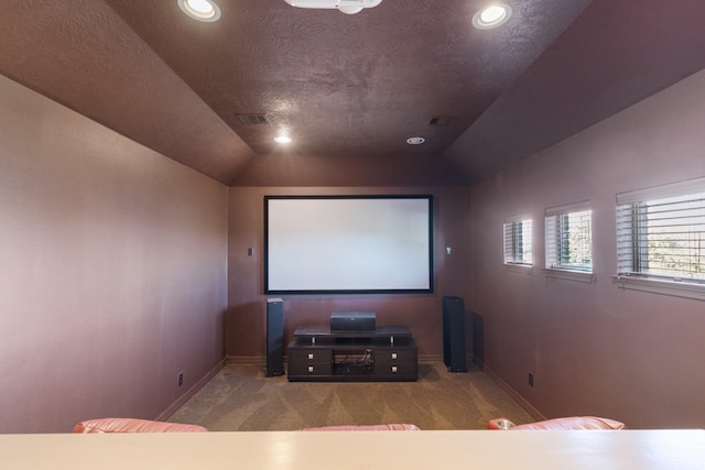 carpeted home theater featuring lofted ceiling, baseboards, visible vents, and recessed lighting