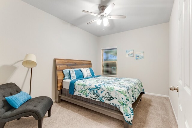 carpeted bedroom featuring baseboards and ceiling fan