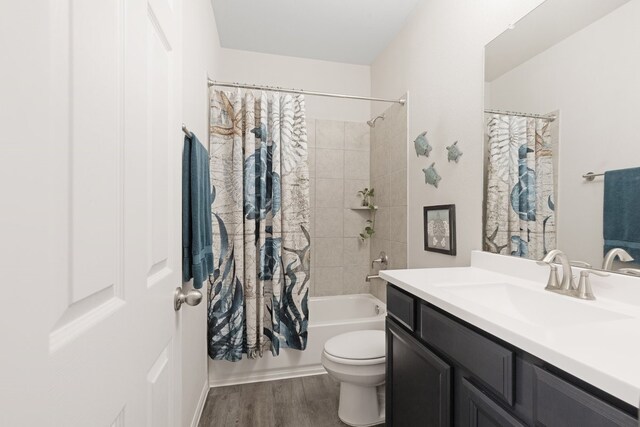 full bath featuring toilet, vanity, shower / tub combo, and wood finished floors