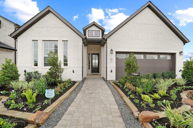 view of front of house with a garage and brick siding