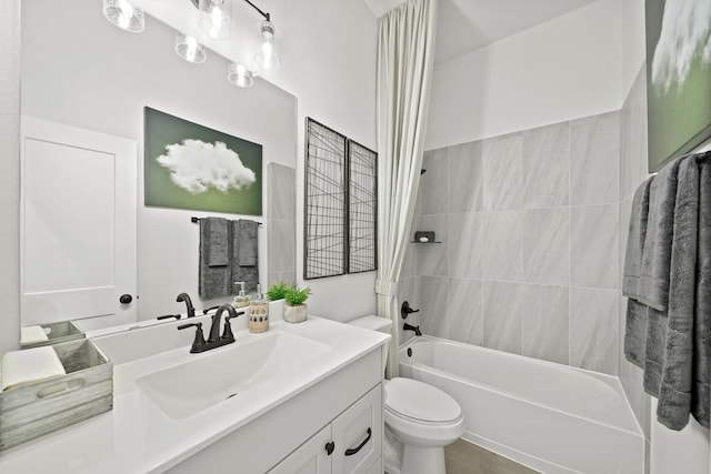 full bathroom featuring tub / shower combination, vanity, and toilet