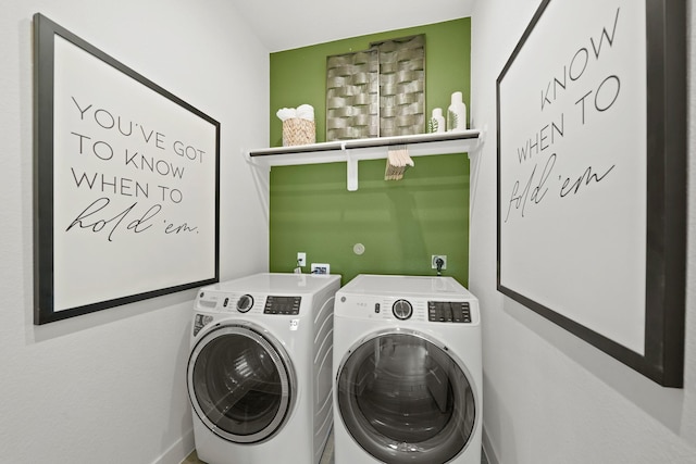 clothes washing area featuring laundry area and washing machine and clothes dryer