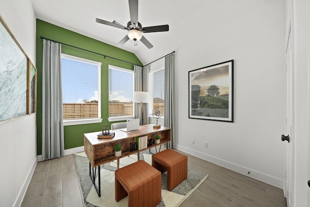 office featuring light wood-type flooring, vaulted ceiling, ceiling fan, and baseboards