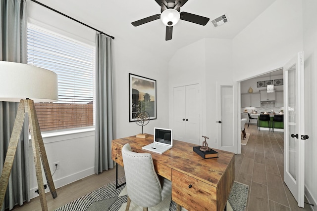 office area featuring a ceiling fan, visible vents, and wood finished floors