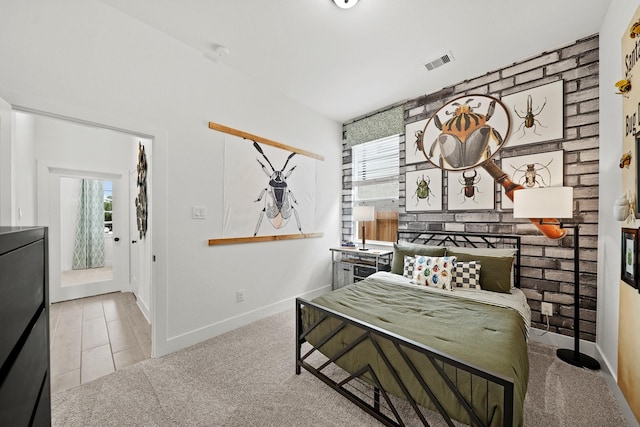 living area with carpet floors, brick wall, visible vents, and baseboards