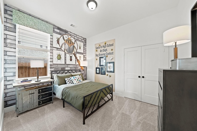 carpeted bedroom featuring visible vents and a closet