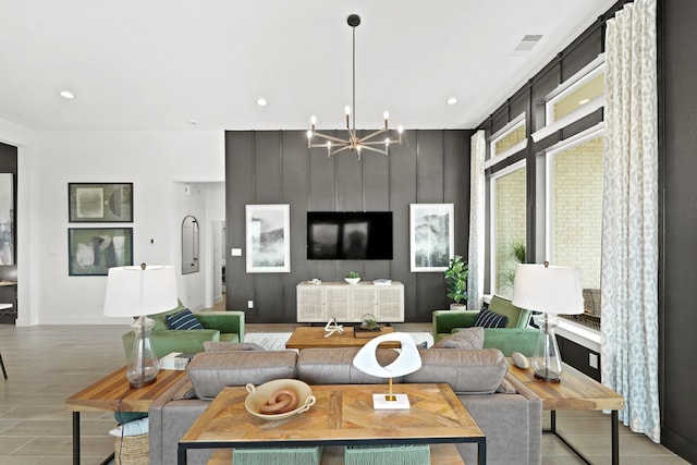 living room with recessed lighting, visible vents, and a notable chandelier