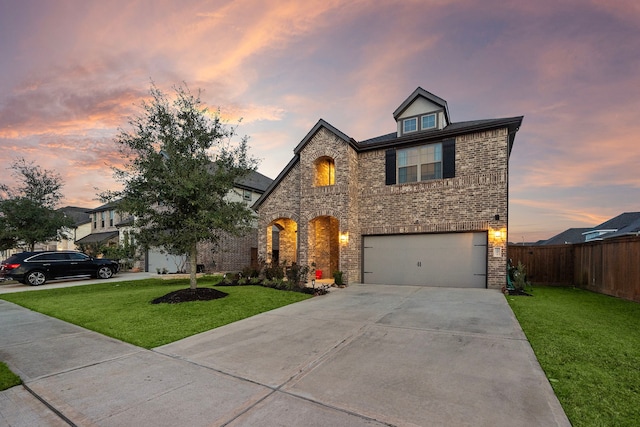 view of front facade with driveway, brick siding, a front lawn, and fence