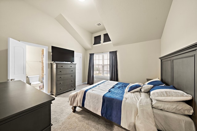 bedroom featuring visible vents, baseboards, ensuite bath, lofted ceiling, and light carpet