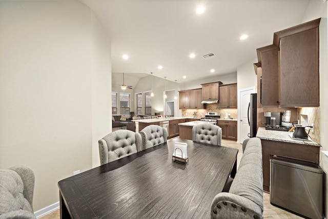 dining room with vaulted ceiling, recessed lighting, visible vents, and baseboards