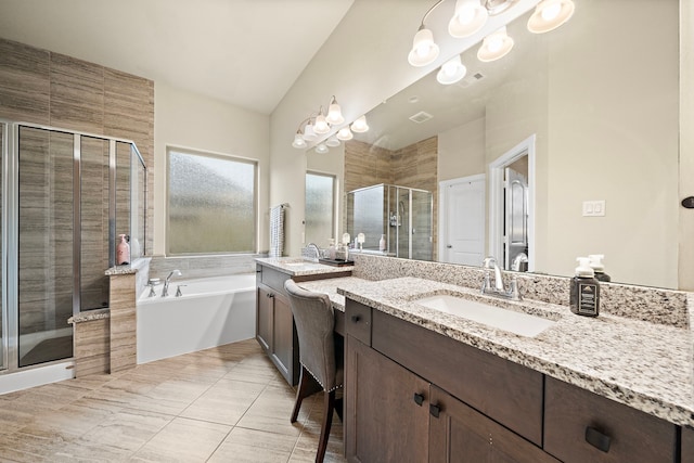 bathroom featuring a sink, two vanities, a stall shower, and a bath