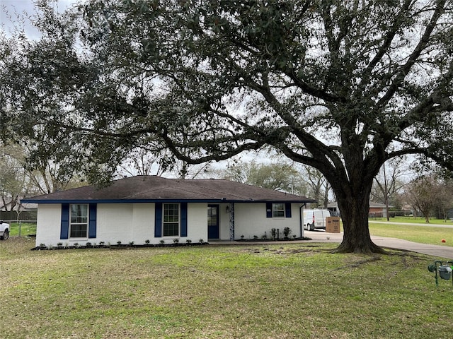 single story home with a front lawn and brick siding