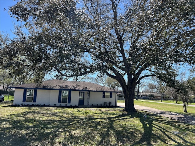 single story home with a front lawn and brick siding