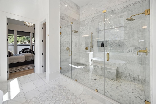 full bathroom with a shower stall and ensuite bath