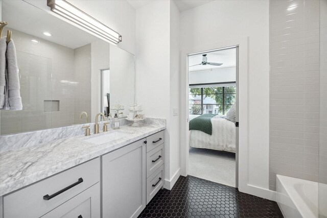 ensuite bathroom featuring tile patterned flooring, connected bathroom, and vanity