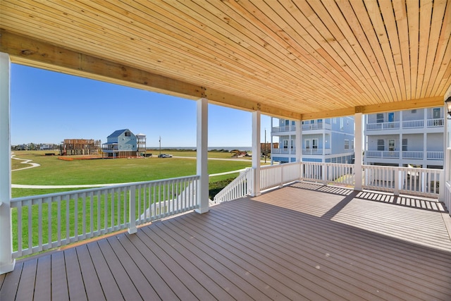 wooden terrace featuring a lawn