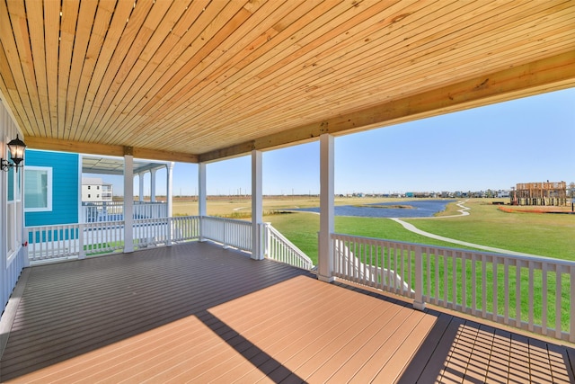 wooden deck featuring a lawn