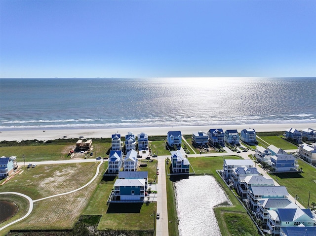 bird's eye view featuring a view of the beach and a water view