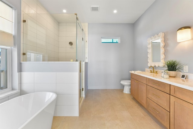 full bathroom with toilet, vanity, visible vents, a soaking tub, and a shower stall