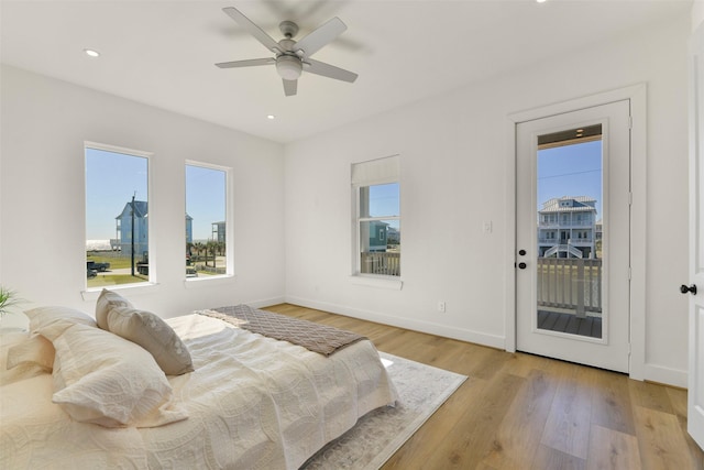 bedroom featuring light wood finished floors, access to outside, baseboards, and recessed lighting