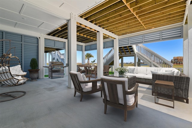 view of patio with stairs, outdoor dining area, and an outdoor living space