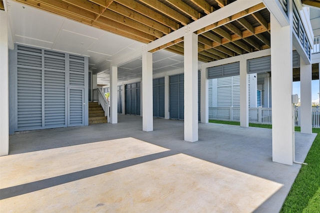 view of patio with a carport and fence