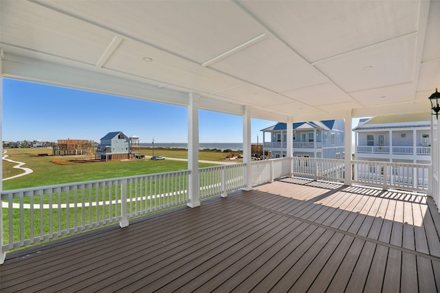 wooden terrace featuring a yard