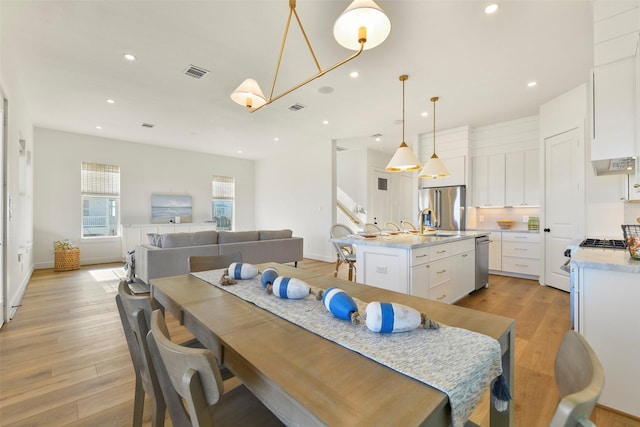 dining space featuring recessed lighting, visible vents, and light wood-style flooring