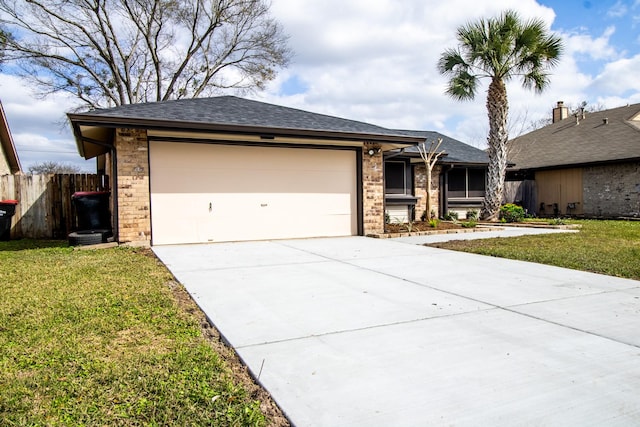 view of front of home with driveway, fence, a front lawn, and an attached garage