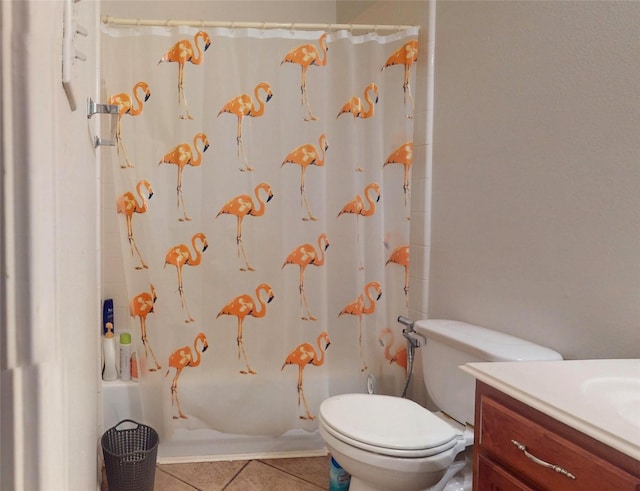 bathroom with tile patterned flooring, toilet, vanity, and shower / tub combo