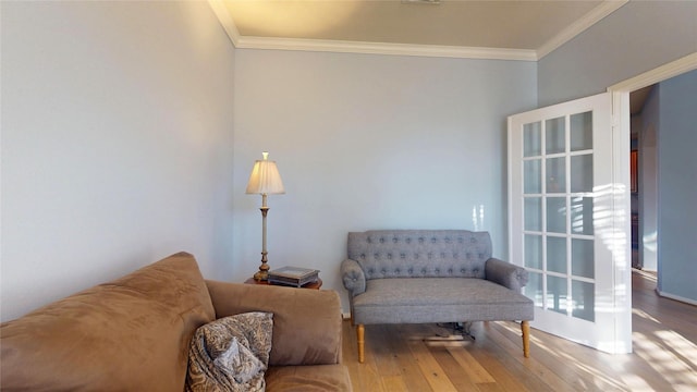 living area featuring ornamental molding and hardwood / wood-style flooring