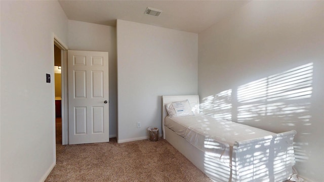 unfurnished bedroom featuring visible vents, carpet floors, and baseboards