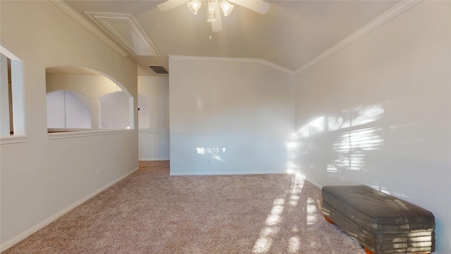 spare room featuring visible vents, attic access, lofted ceiling, ceiling fan, and crown molding