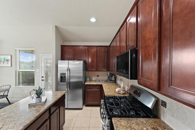 kitchen with light tile patterned floors, light stone counters, recessed lighting, dark brown cabinets, and appliances with stainless steel finishes