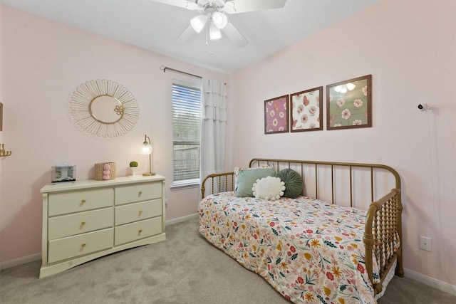 carpeted bedroom with baseboards and a ceiling fan