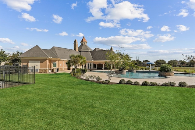 view of yard featuring a patio, fence, and an outdoor pool