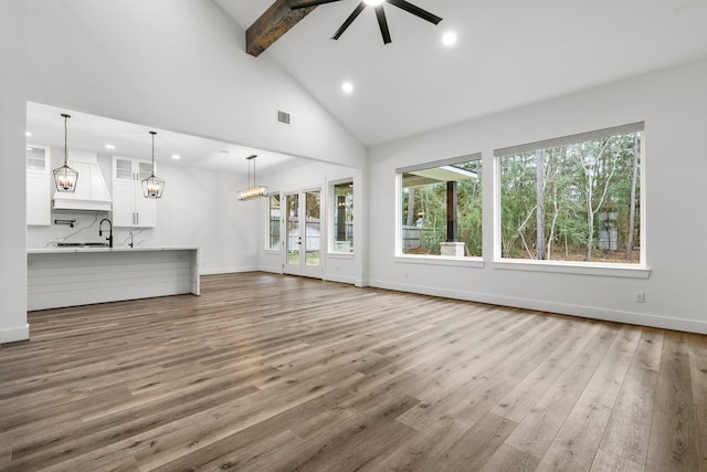 245 E Blue Heron Dr, Montgomery, TX 77316 - unfurnished living room with beamed ceiling, wood finished floors, recessed lighting, high vaulted ceiling, and a ceiling fan