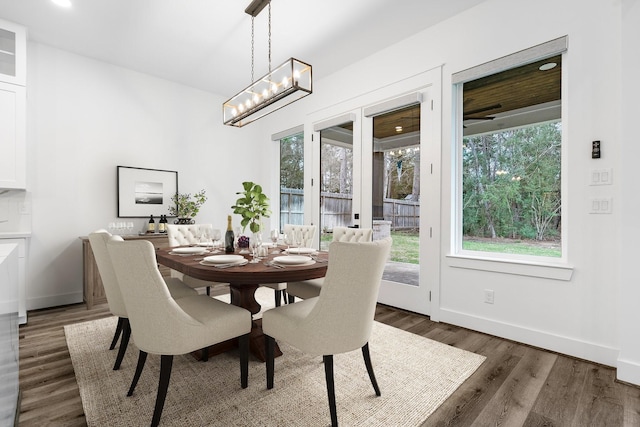 245 E Blue Heron Dr, Montgomery, TX 77316 - dining area featuring plenty of natural light, wood finished floors, and a chandelier