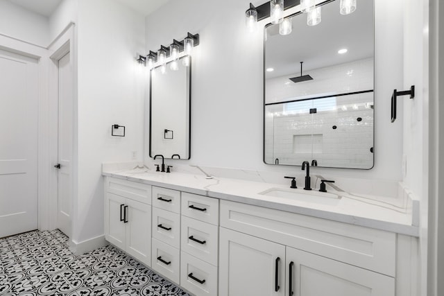 bathroom with double vanity, a stall shower, a sink, and recessed lighting