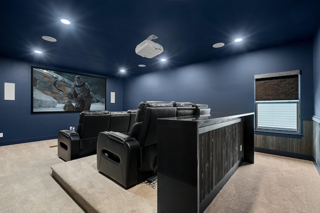 carpeted home theater room featuring wooden walls, wainscoting, and recessed lighting