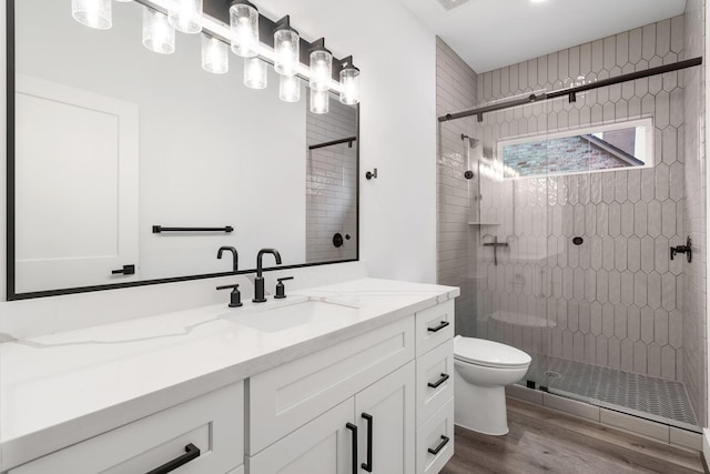 245 E Blue Heron Dr, Montgomery, TX 77316 - full bathroom featuring vanity, wood finished floors, and a stall shower