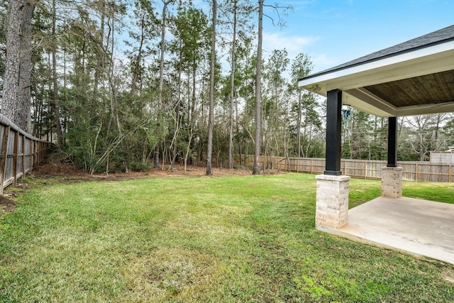 view of yard featuring a patio area and a fenced backyard