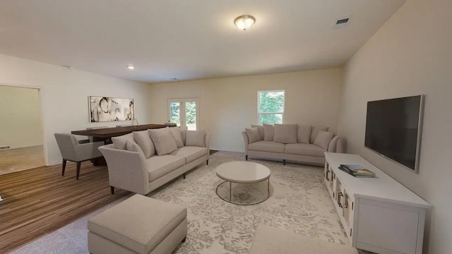 living room featuring light wood-type flooring and visible vents