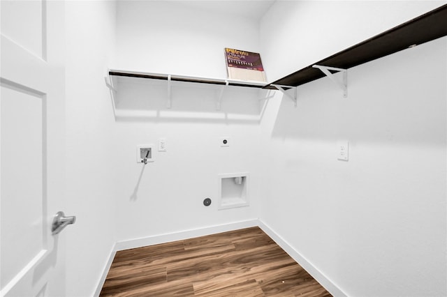 washroom with dark wood-type flooring, laundry area, electric dryer hookup, and baseboards